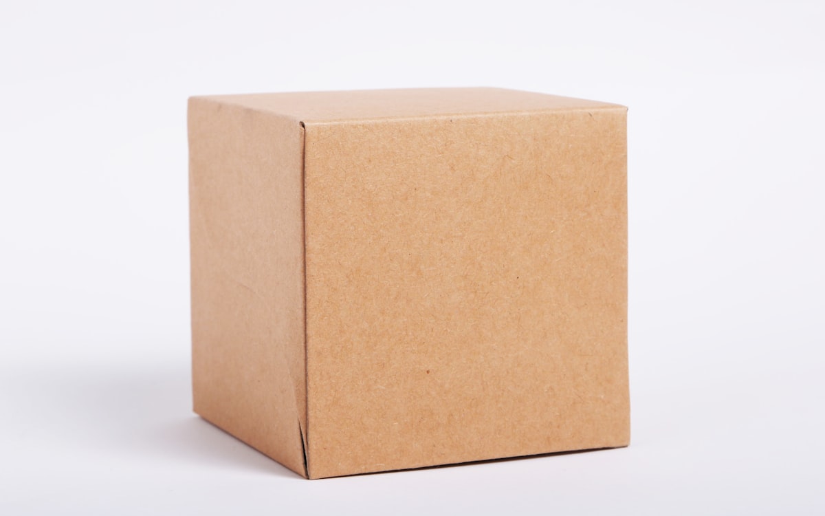 Small shop worker packing shipping boxes on a workbench